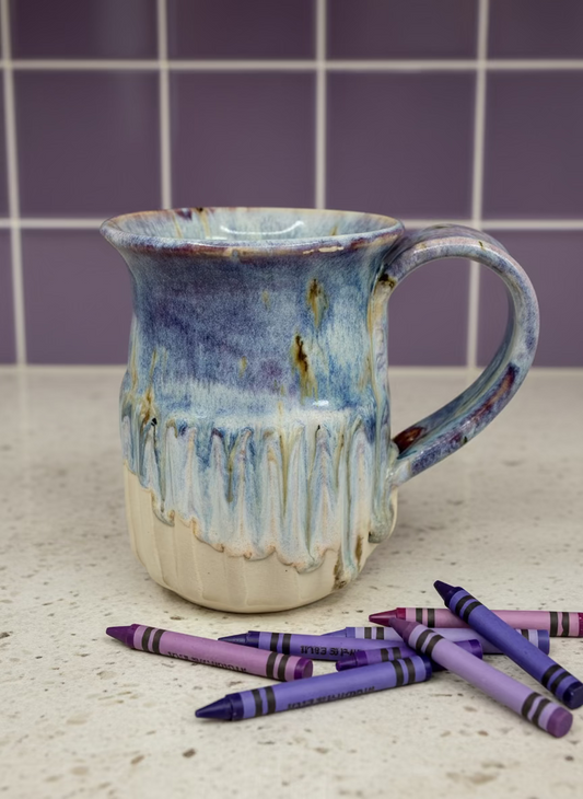 Ceramic mug with blue and white glaze on a white background
